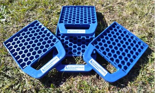 Set of four OziBlock n Chock leg pads with handles. Durably built to support caravan or camper trailer stability. For sale in Sunshine Coast Queensland.