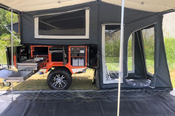 Jawa Camper Trailer with large alfresco annexe with floor and walls set up connected to awning and camping mat.