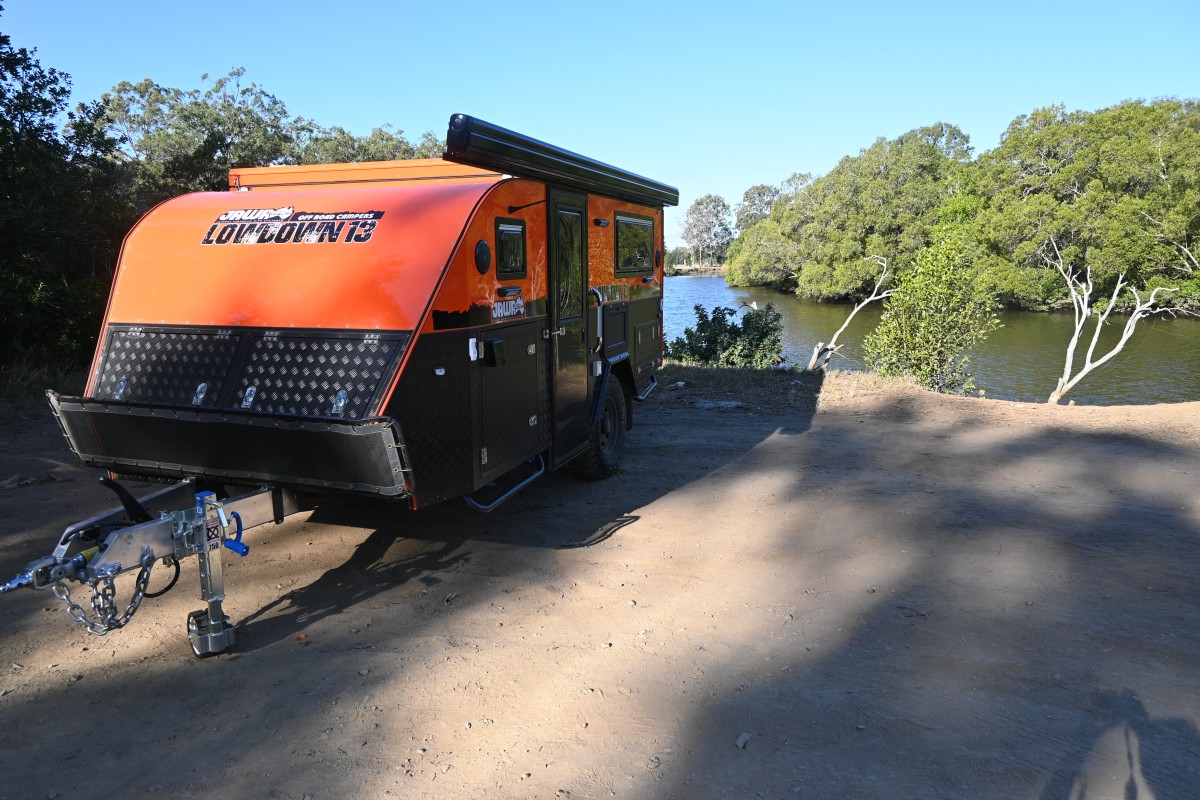 Jawa Lowdown 13 parked by creek. Low height Hybrid Caravan with roof folded down for ease of towing. For sale at Jawa Off Road Camper Trailers Sunshine Coast Queensland.