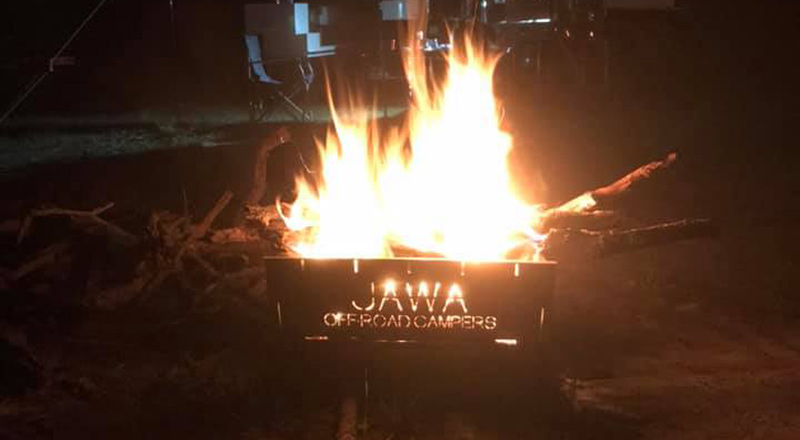 Jawa Off Road Camper Trailers Fire Pit in use at night with a large fire lit in it. Available in Sunshine Coast Queensland.