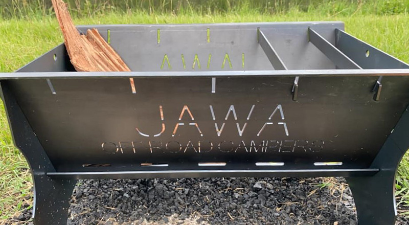 Available in Sunshine Coast Queensland Jawa Off Road Camper Trailers Fire Pit made from metal with coals underneath at a campsite.