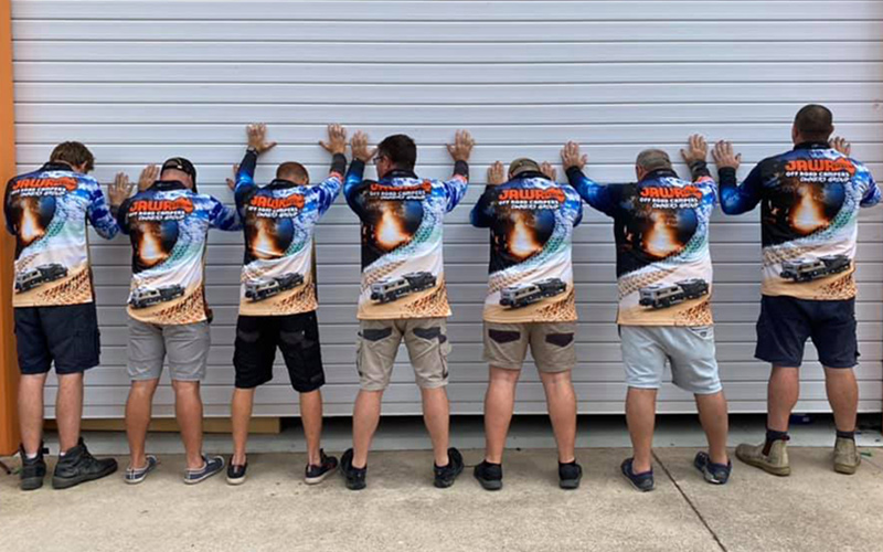 Jawa Off Road Camper Trailers collared long sleeve blue fishing shirts worn by six different men of varying ages and sizes back view. Available in Sunshine Coast Queensland.