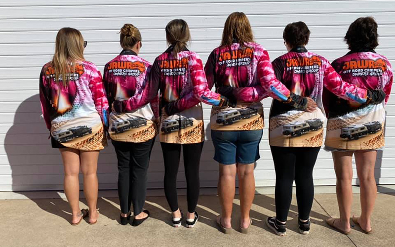 Jawa Off Road Camper Trailers Long sleeve pink fishing shirts worn by six different women of varying ages and sizes back view. The women have their arms around each other. Available in Sunshine Coast Queensland.