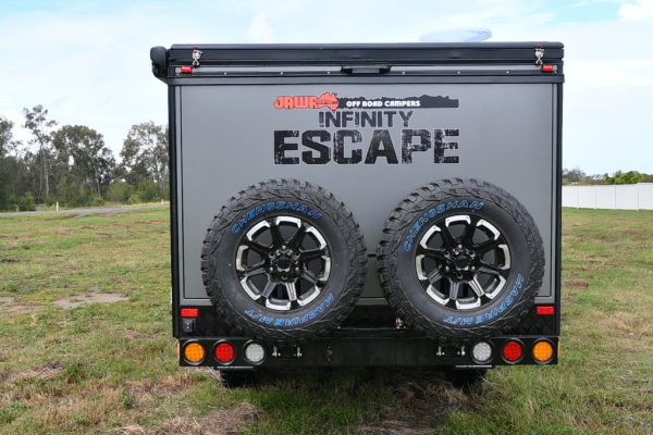 Back of Infinity Escape by Jawa Off Road Camper Trailers. Two spare tyres are stored on the back with tough exterior and logo on the large family hybrid caravan. In stock at Sunshine Coast Queensland.