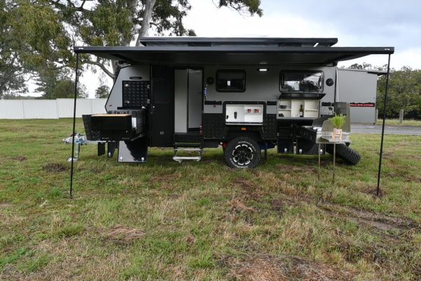 Jawa Infinity Escape Hybrid Caravan parked on side of the road with awning set up, roof popped up and back extended to the full 18 feet length. Very large Off Road Camper Trailer for the Family available in Sunshine Coast Queensland.