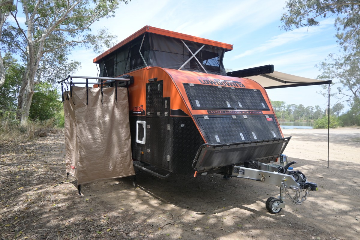Jawa Lowdown 13 Cupboard Hybrid Caravan fully set up at a reserve. External shower set up around the back of the caravan with awning and roof set up for extra height and comfort. Camper trailers available for purchase in Sunshine Coast Queensland.