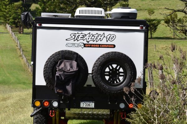 Back view of Stealth 10 Caravan by Jawa Off Road Camper Trailers on grassy land. Small pint sized caravan available at Sunshine Coast Queensland.