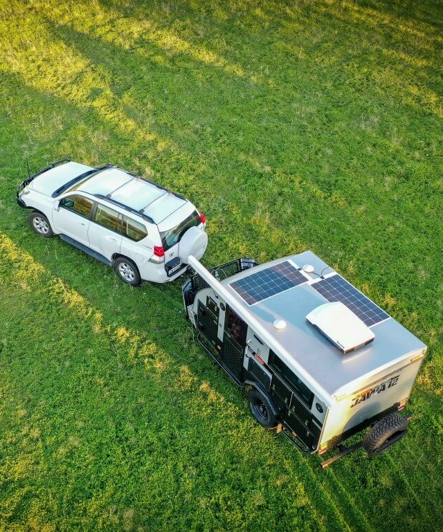 Car doing some practise manoeuvring with the hybrid caravan in an open and safe environment.  Consider a course in towing prior to hitting the road with your camper or caravan for the first time.